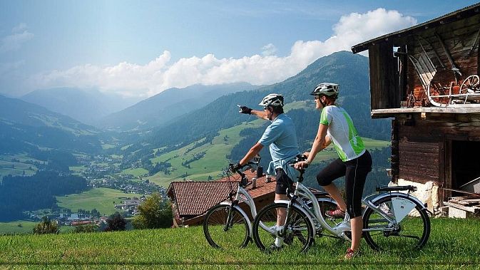E-bike riders overlooking an alpine valley